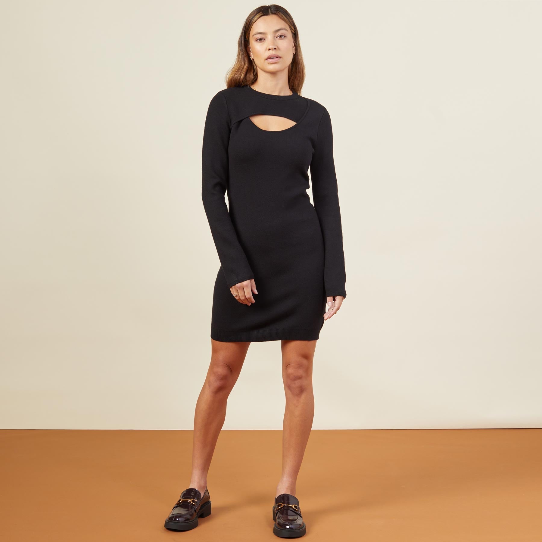 Front view of model wearing the supersoft sweater knit cut out dress in black.