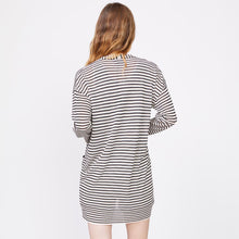 Back view of model wearing the stripe sweater cardigan in ivory stripe.