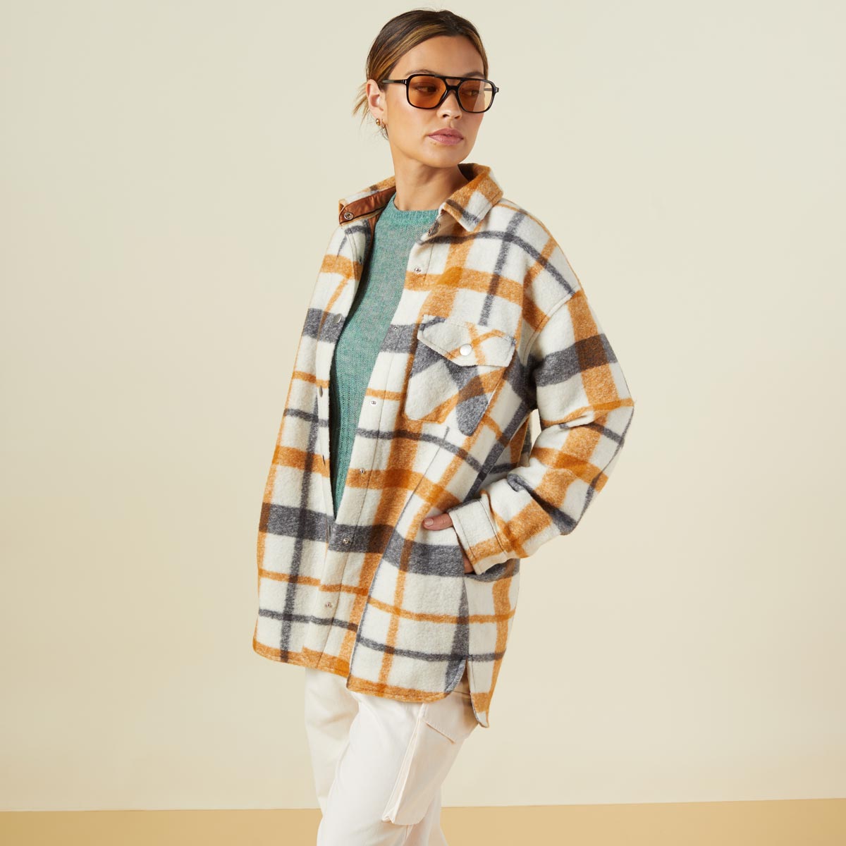 Side view of model wearing the plaid shacket in black, natural, caramel.