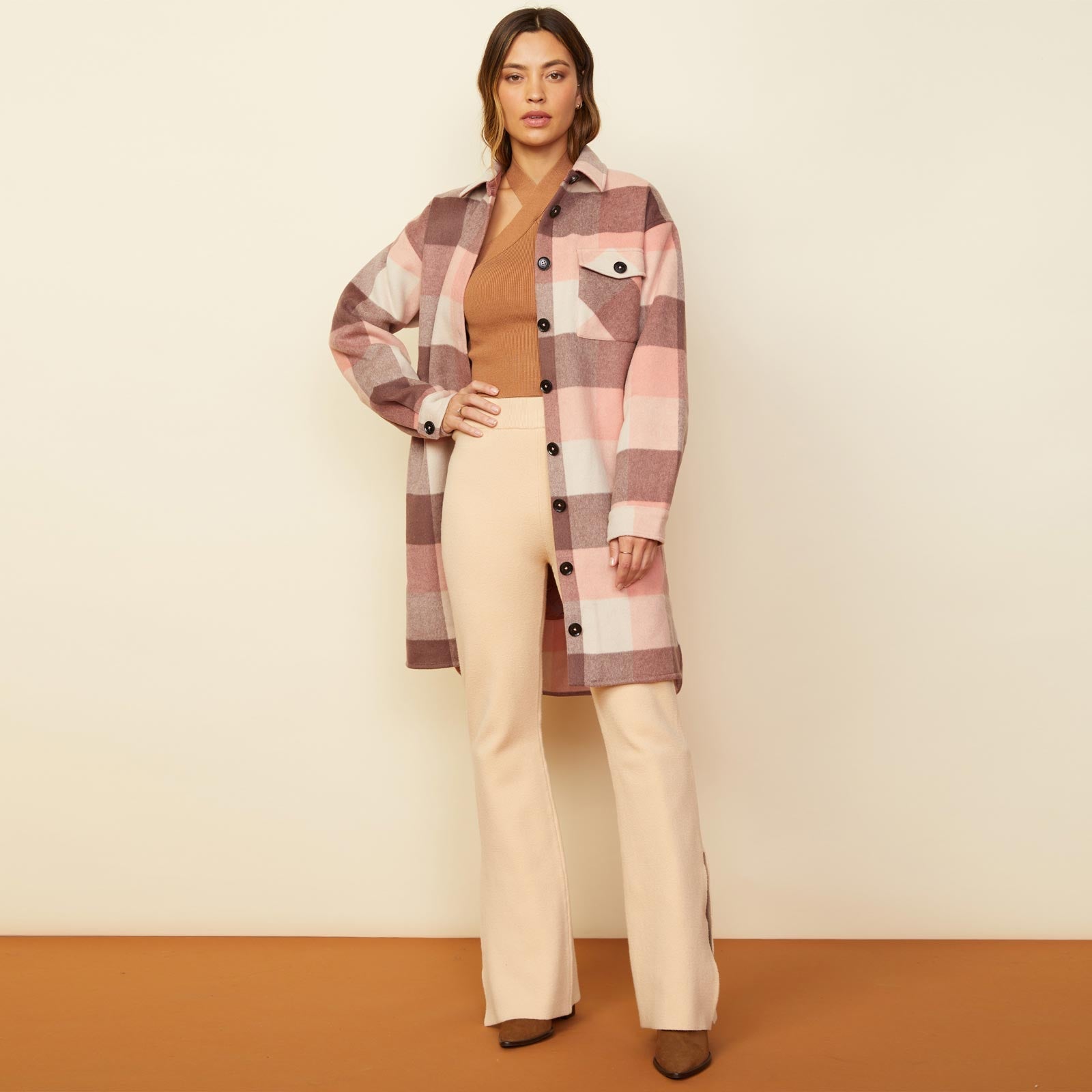 Front view of model wearing the long woolen shirt jacket in pink.