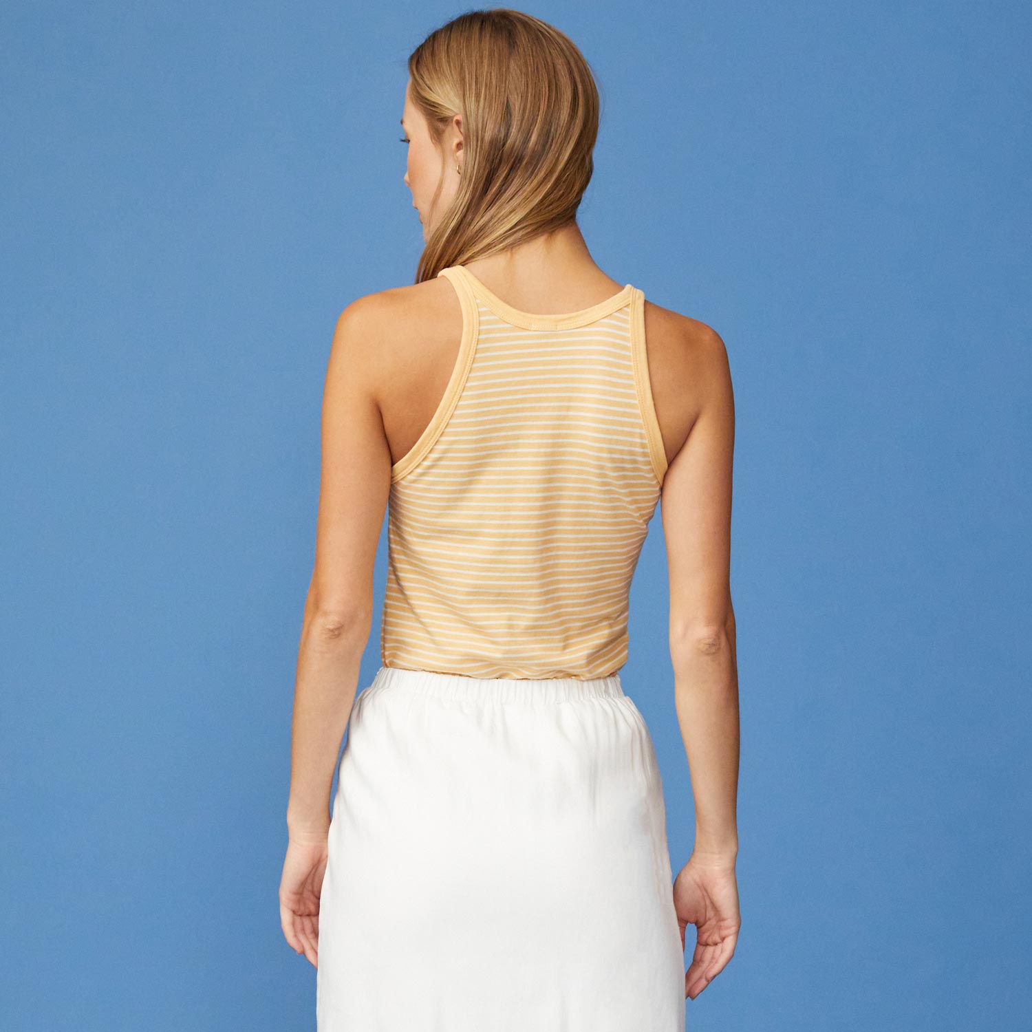 Back View of model wearing the Stripe Narrow Tank in Sand