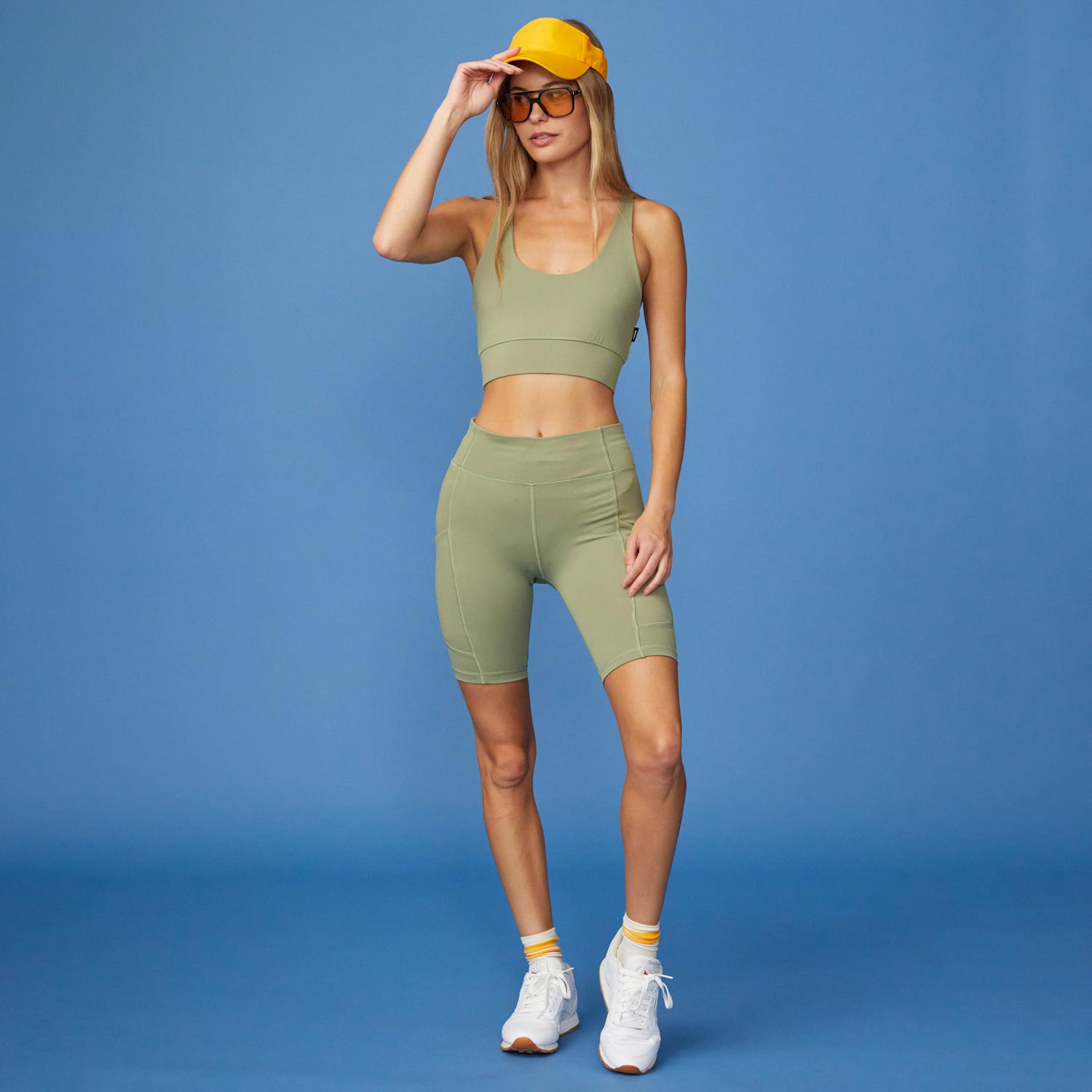 Full View of model wearing the Movement Sports Bra in Army