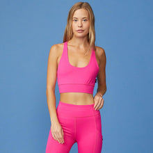 Front View of model wearing the Movement Sports Bra in Raspberry