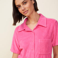 Close up view of model wearing the terry cloth pocket shirt in azalea.