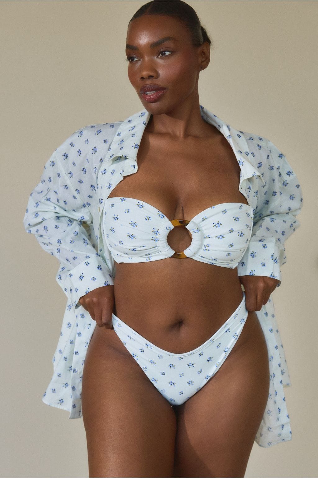 White bikini bottom with small blue floral print and high-waisted cut with curved sides.