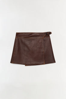 Brown leather mini skirt with wrap-front design and buckle closure at waist.