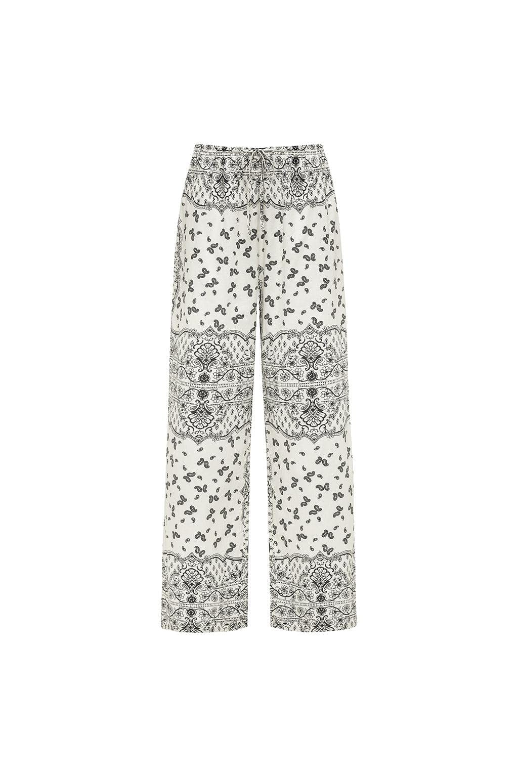 Cream and black wide leg pants with bandana print and decorative lace panel details throughout.