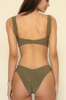 Khaki bikini bottom with zig-zag stitching down the center front, high-cut leg openings, and matching bikini top visible.