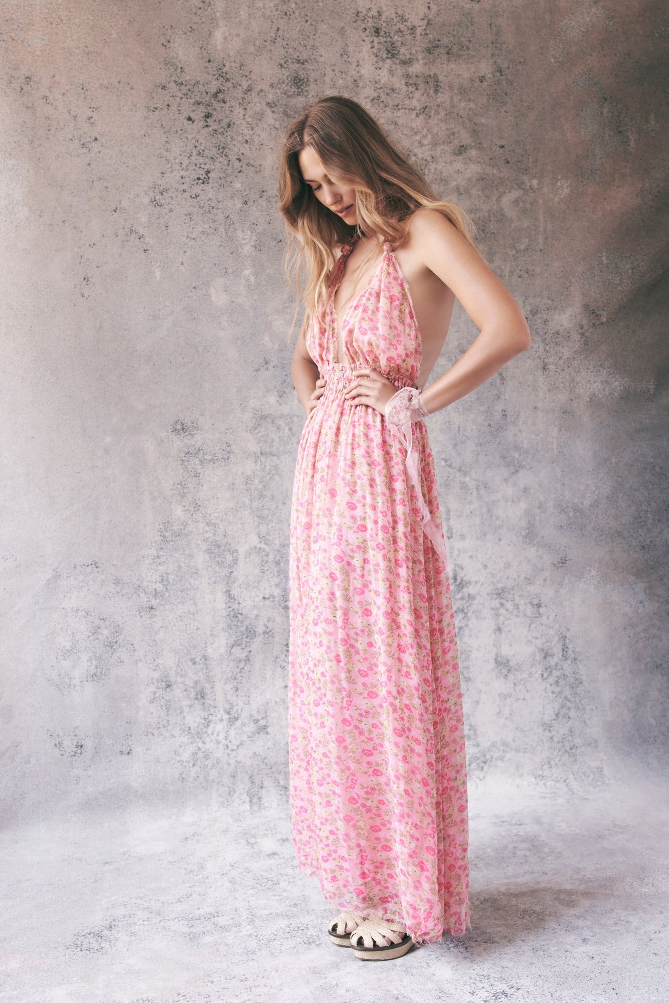 Model wearing pink floral halter maxi dress