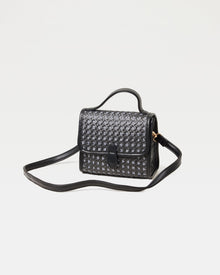 Off-model image of the Amelia Bag in black, a structured mini woven top-handle crossbody bag, with the crossbody strap extended.