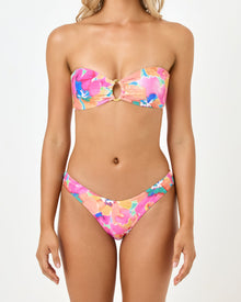 close up view of woman wearing a colorful bikini set on a white background
