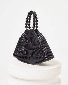 Side view of the Starlight Bag in black on a white pedestal.
