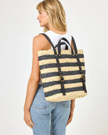 Back view of model wearing the Summer Days Backpack in natural-black, paired with a white tank top and jeans.