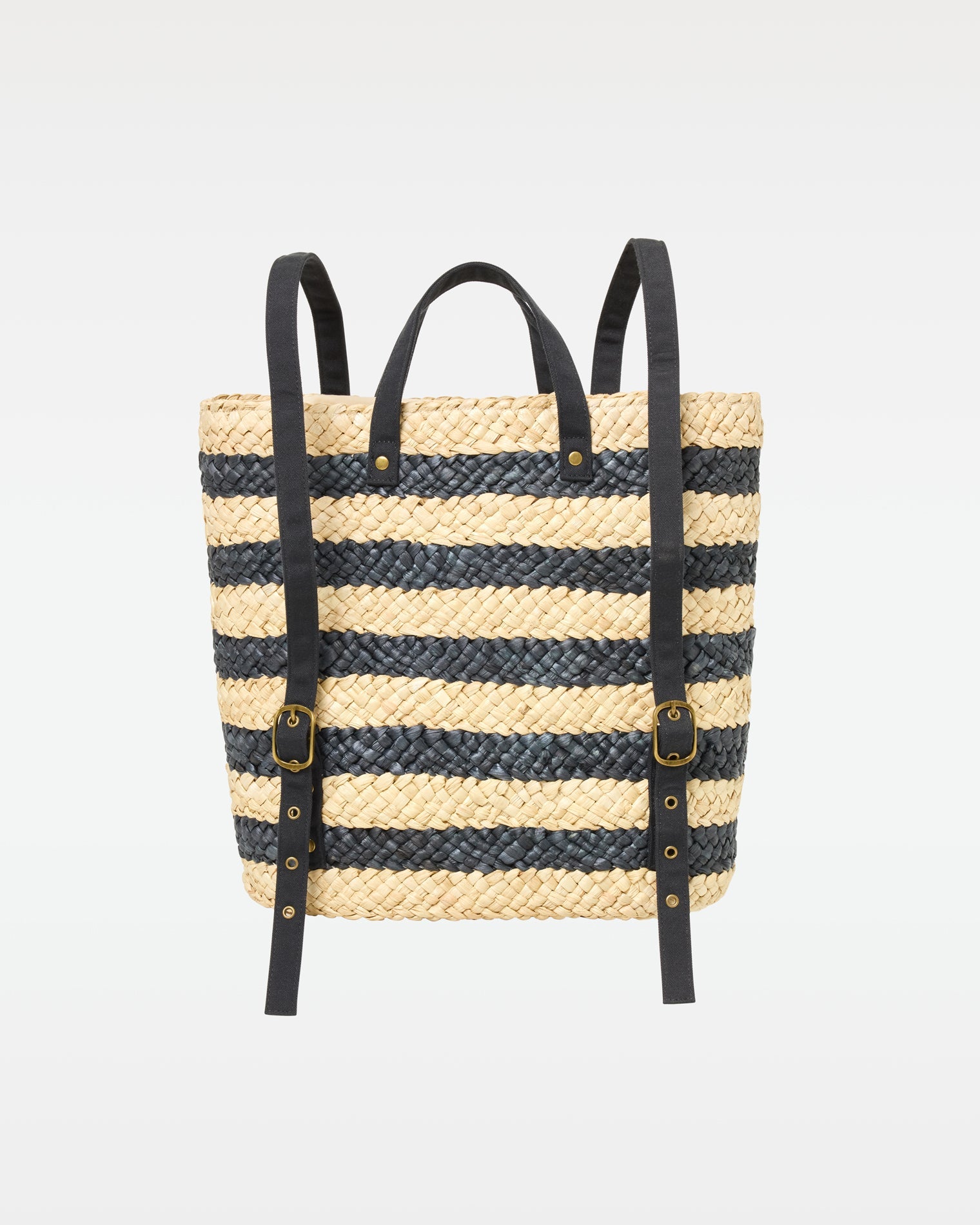 Back view of the Summer Days Backpack in natural-black showing the natural and black stripe woven body and black leather backpack straps.