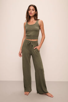 Model wears Recycled Sweater Pant in Moss.