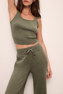 Model wears Recycled Sweater Pant in Moss.