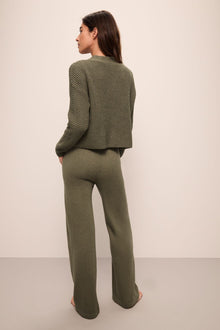 Model wears Recycled Sweater Pant in Moss.
