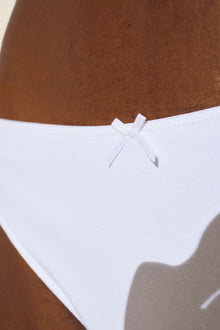 Model wears Pima Stretch Cotton Thong in White.