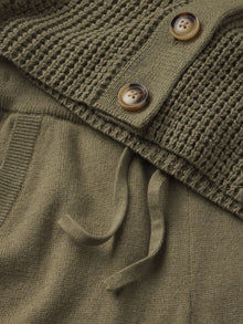 Model wears Recycled Sweater Pant in Moss.