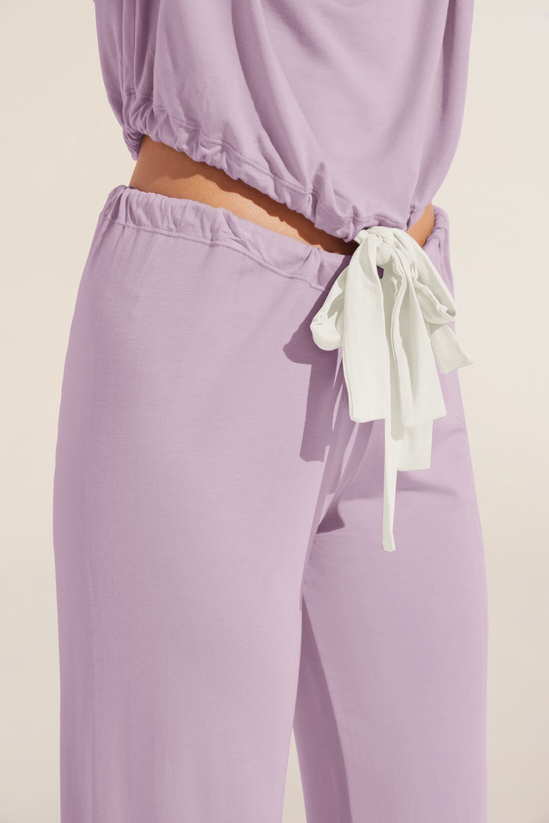 Model wears Gisele TENCELâ„¢ Modal Slouchy PJ Set in lavender/ivory.