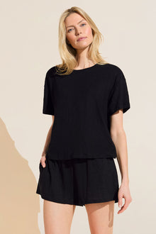 Model wears Organic Linen Knit Short Sleeve T-Shirt in Black.