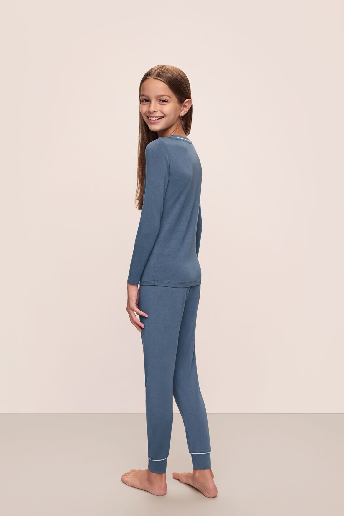 Model wears Kids TENCEL Modal Unisex Long PJ Set in Coastal Blue/Ice Blue.