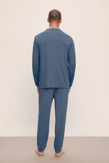 Model wears Henry TENCELâ„¢ Modal Long PJ Set in Coastal Blue.