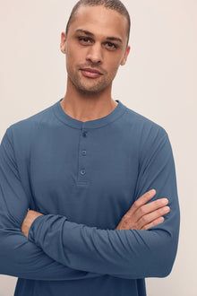 Model wears Henry TENCELâ„¢ Modal Long PJ Set in Coastal Blue.
