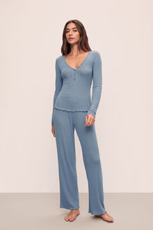 Model is wearing Pointelle V Neck Henley in Faded Denim