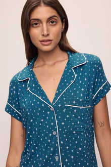 Model wears the Gisele Printed TENCELâ„¢ Modal Relaxed Short PJ Set in Festive Lights Sapphire/Ivory.