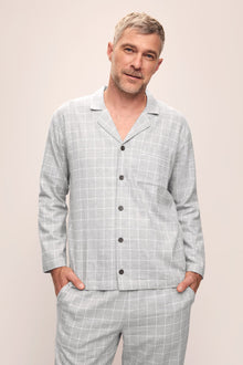 Model is wearing Men's Flannel Long PJ Set in Wintercheck Heather Grey/Ivory.
