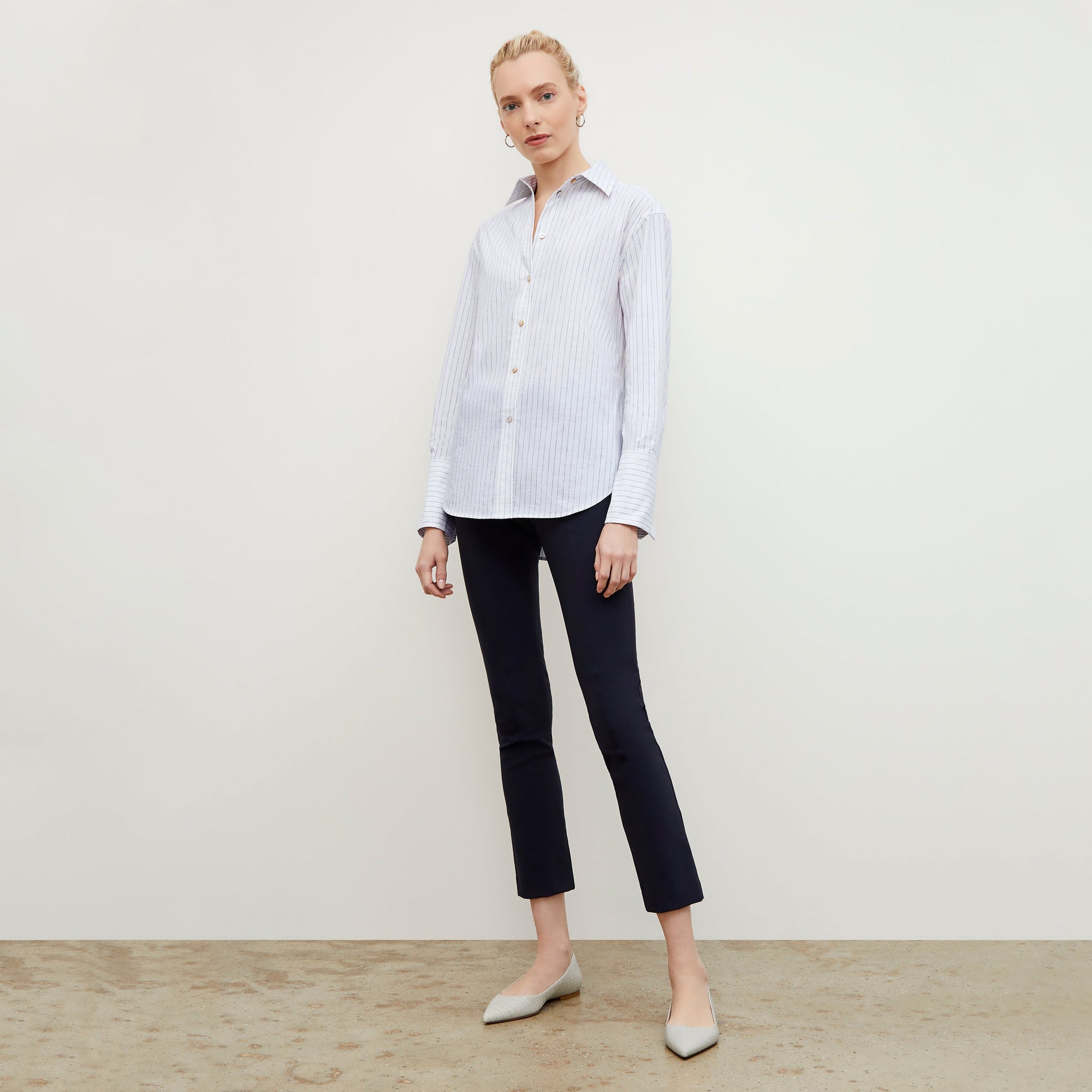 Front image of a woman standing wearing the foster pant in dark navy | Exclude