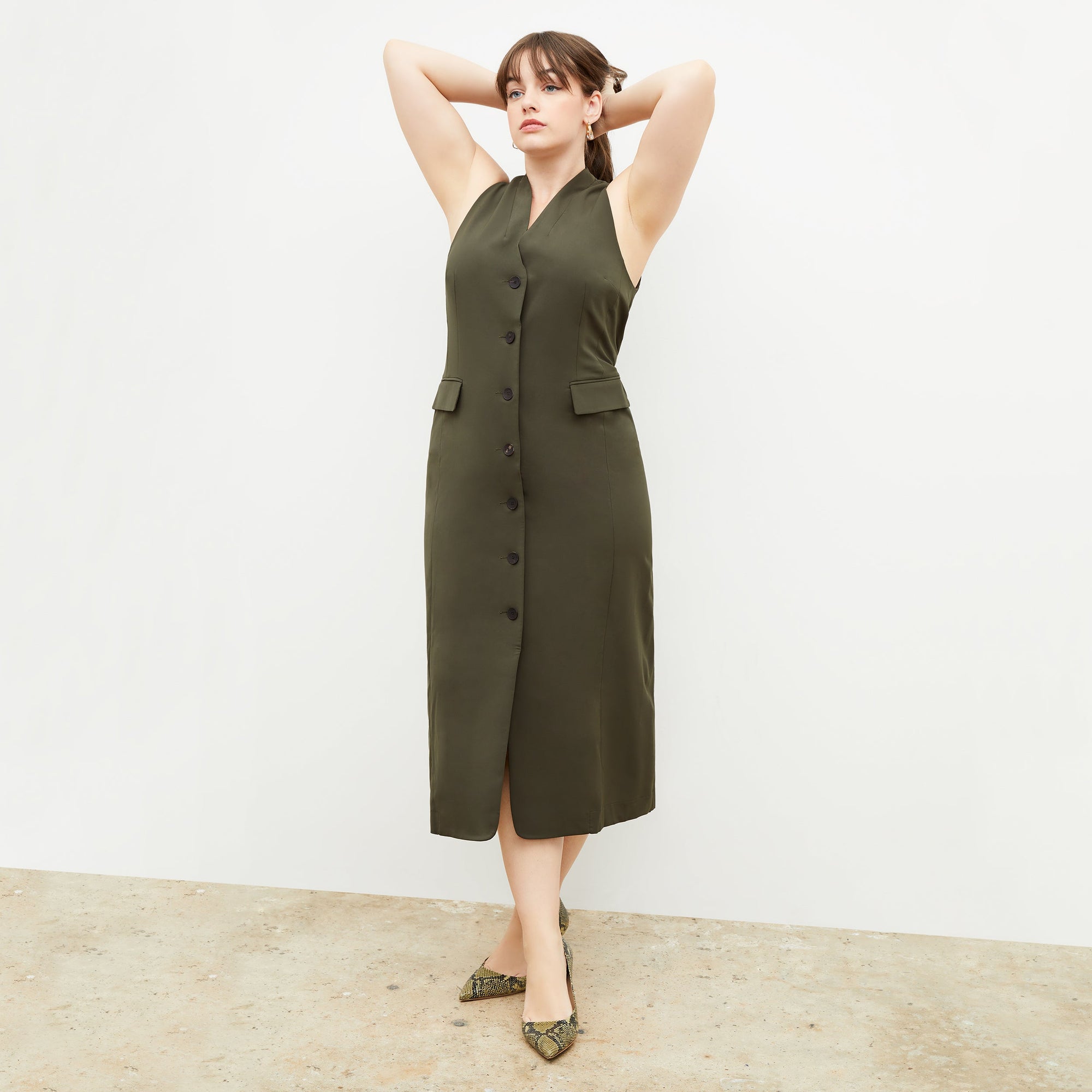 Back image of a woman wearing the Cassandra dress in origamitech in olive | Exclude
