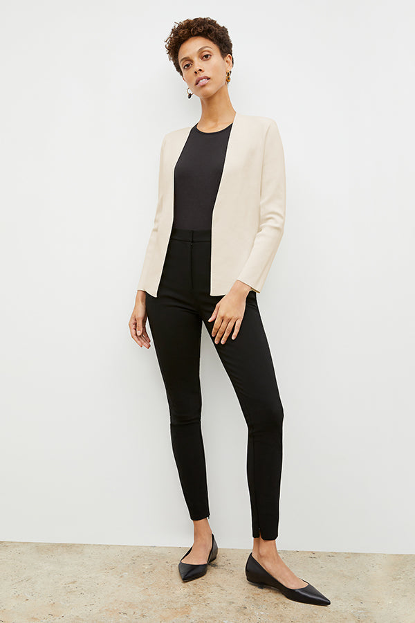 Front image of a woman standing wearing the curie pant in black | Exclude
