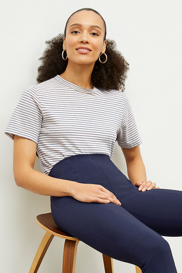 Front image of a woman standing wearing the foster pant in dark navy | Exclude