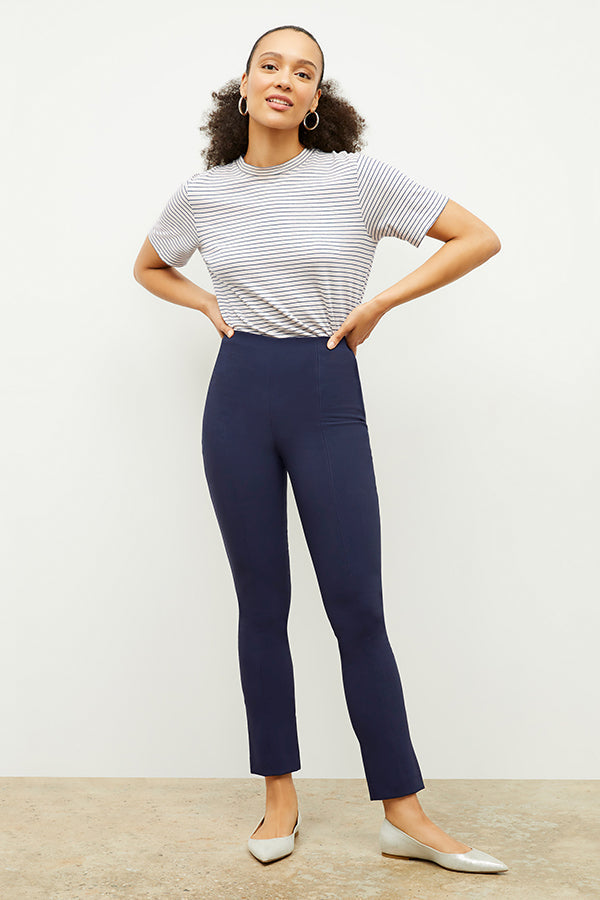 Front image of a woman standing wearing the foster pant in dark navy | Exclude 