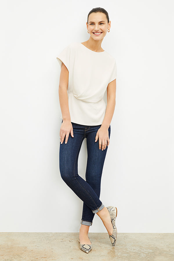 Front image of a woman standing wearing the Nejvi Top in alabaster | Exclude | Grid