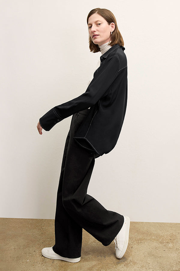 front image of a woman wearing the mira top in black | Exclude