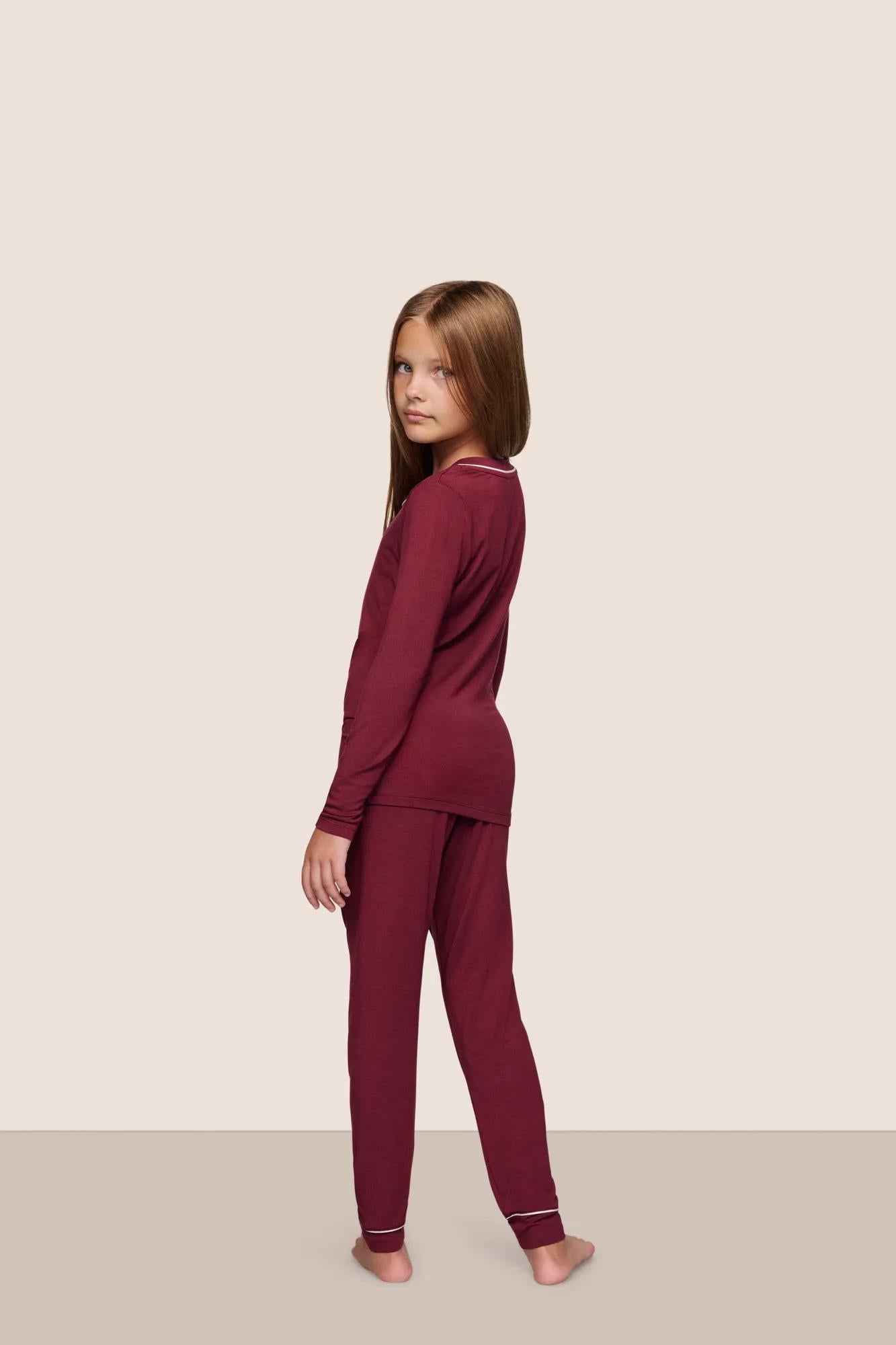 Model is wearing Kids TENCEL Modal Unisex Long PJ Set  in Bordeaux/Ivory