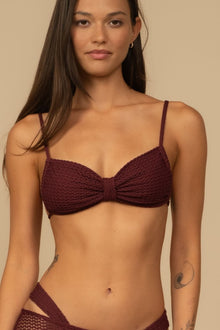 Maroon crochet bikini top with sweetheart neckline and thin shoulder straps.