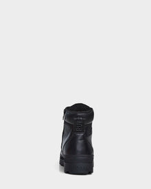 The Rudsak ARTUR - M223501 Black men's ankle boots, crafted from weather-treated leather with a side zipper, pull tab, and RUDSAK embossed heel, are shown from the back against a white background.