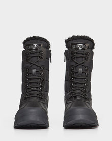 The REAGAN - 6222500 BLACK mens winter boots by Rudsak feature thick soles, lace-up fronts, and faux fur lining at the top. Shown facing forward on a plain white background.