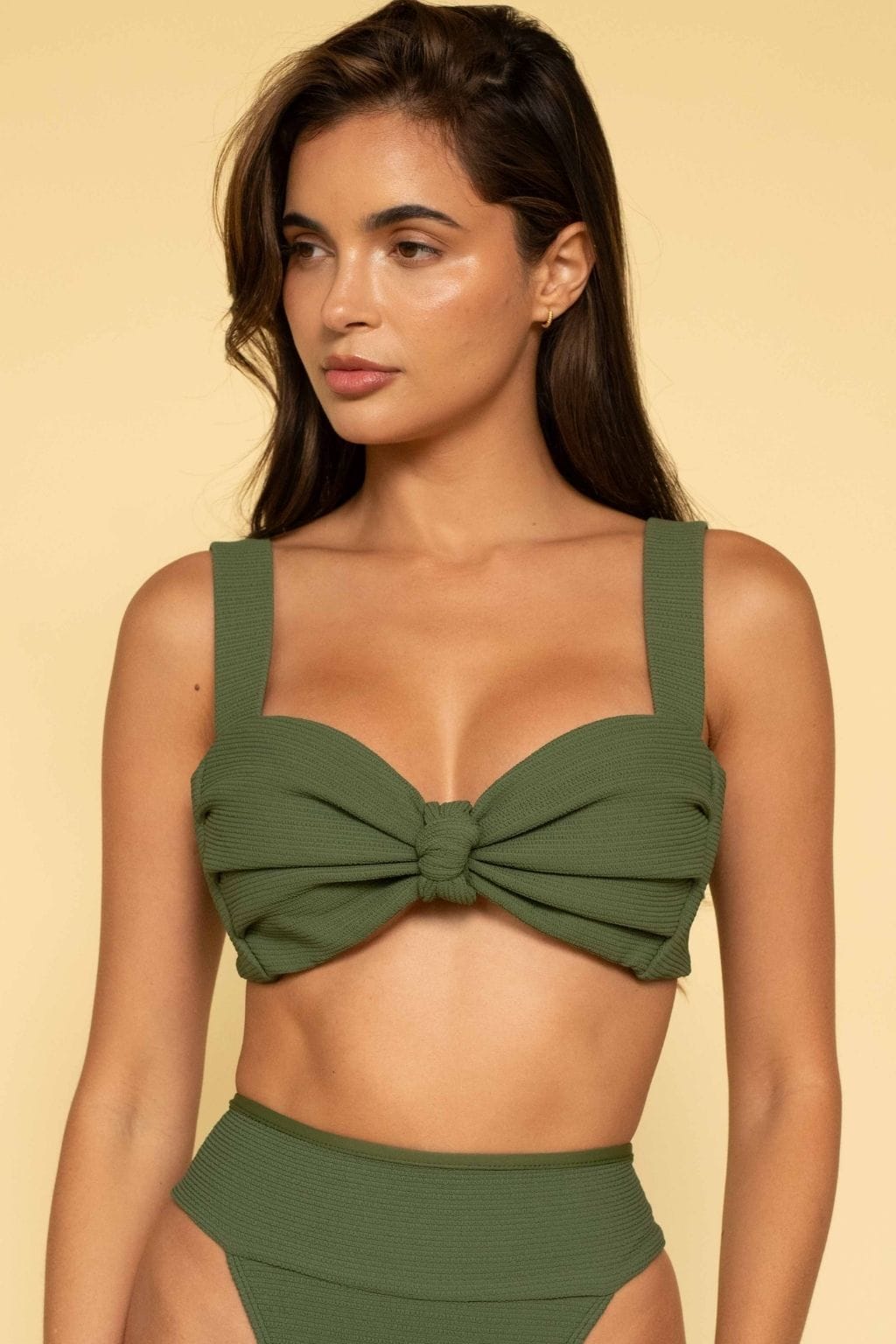Olive green bikini top with square neckline, textured fabric, and center bow detail with thin shoulder straps.