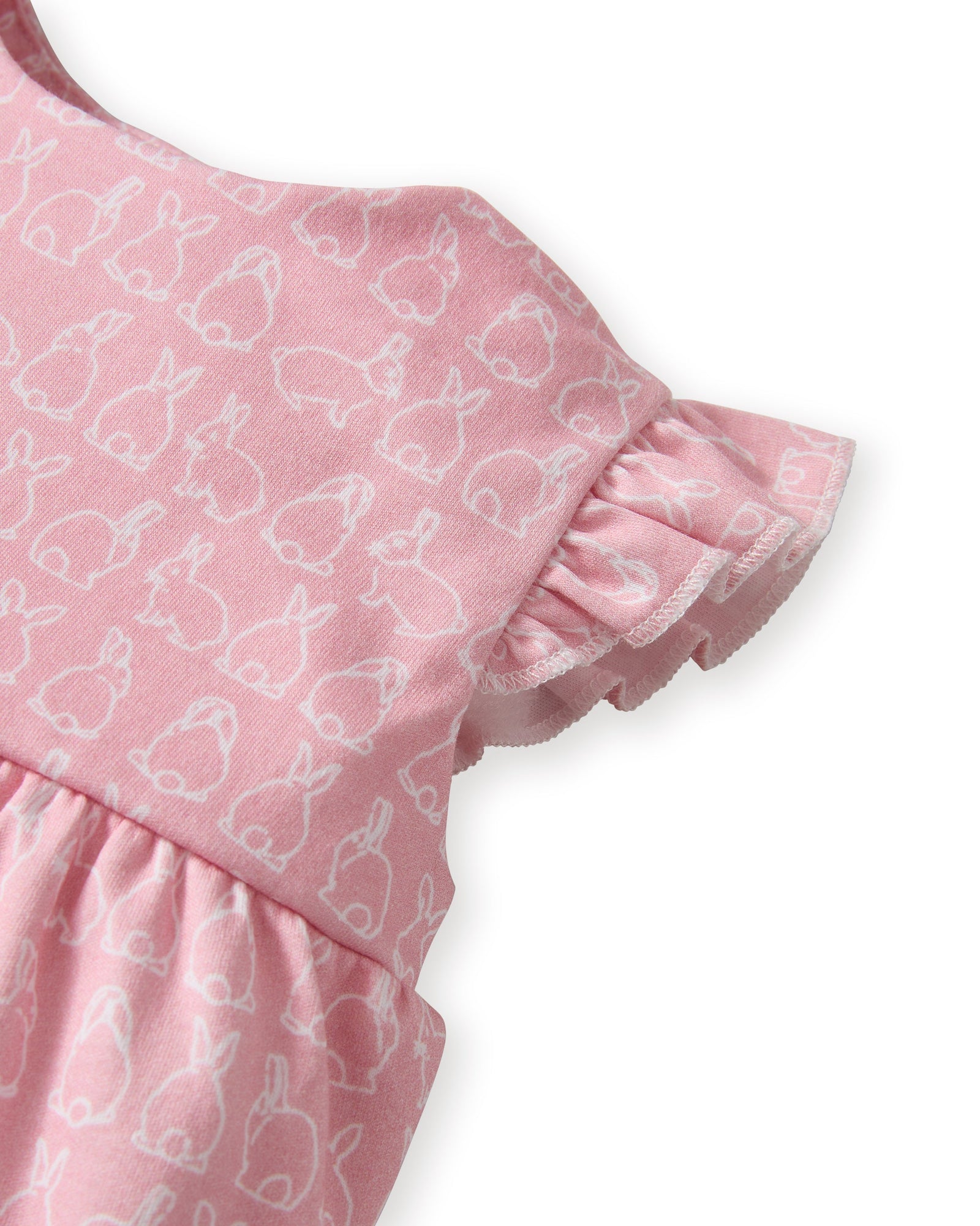 Baby's Pima Isla Play Romper in Hoppy Days Pink features flutter sleeves, ruffled leg openings, a gathered waist, and an allover white bunny outline print. Shown laid flat on a white background.
