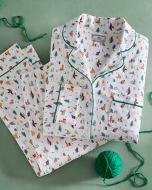 Men's Pima Pajama Set in Merry Meow: white set with green piping, featuring an all-over print of playful colorful cats. Includes a long-sleeve button-up shirt with chest pocket and matching pants.