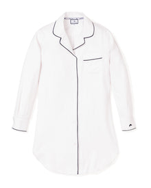 The Womens Pima Nightshirt in White with Black Piping by Petite Plume offers the comfort of luxurious pajamas, crafted from soft Pima cotton. Featuring a single chest pocket, black piping, and rounded hem, it balances classic design and sophistication perfectly.