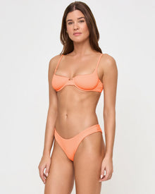 side view of woman wearing orange textured bikini set
