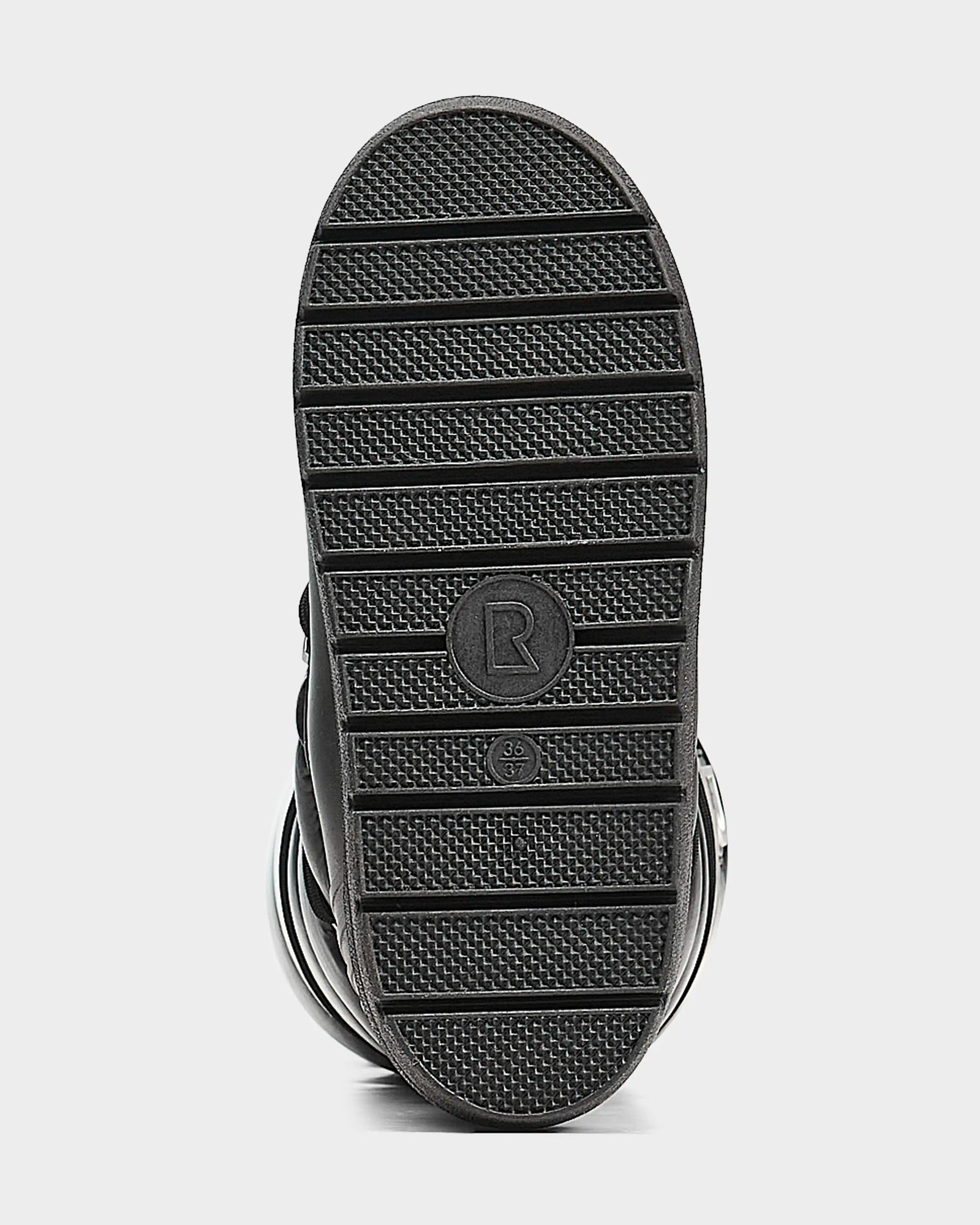 The image shows the bottom sole of the Rudsak TISH - L223508 Pewter womens winter boot, featuring black horizontal grooves, a circular center marked with R and size 34 2/3, and a sturdy platform for added style and comfort.