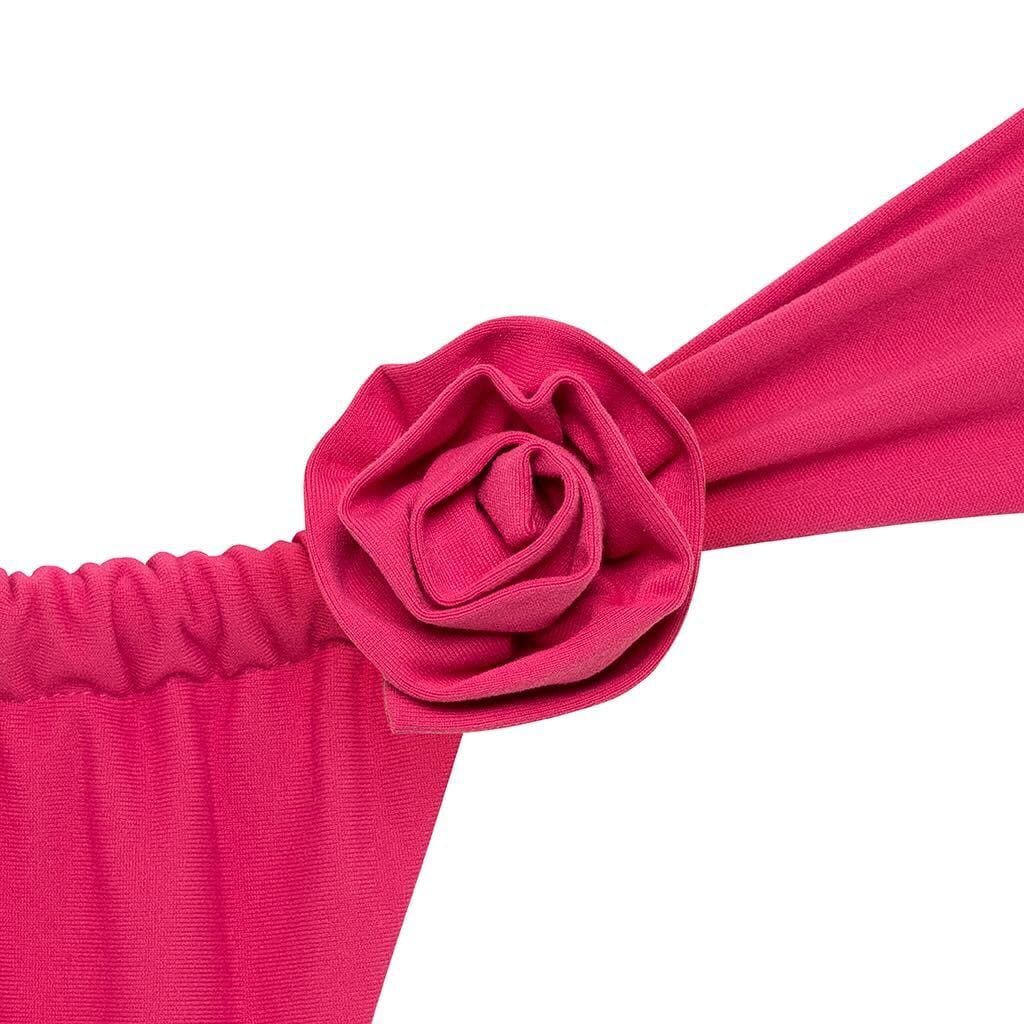 Bright pink fabric rose pin attached to matching pink elastic band and draped fabric.