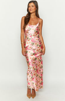 Front view of a yellow satin maxi dress with a pink and red floral print, featuring a cowl neck and thin spaghetti straps